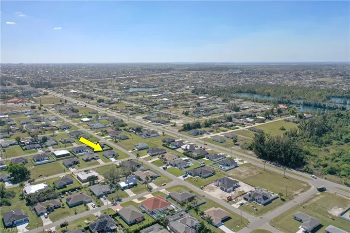 Aerial view of residential area featuring a large body of water