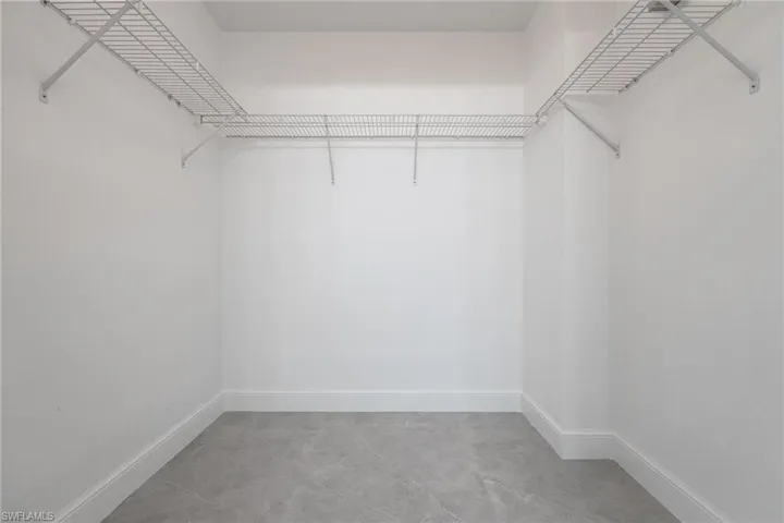 Primary bedroom walk in closet
