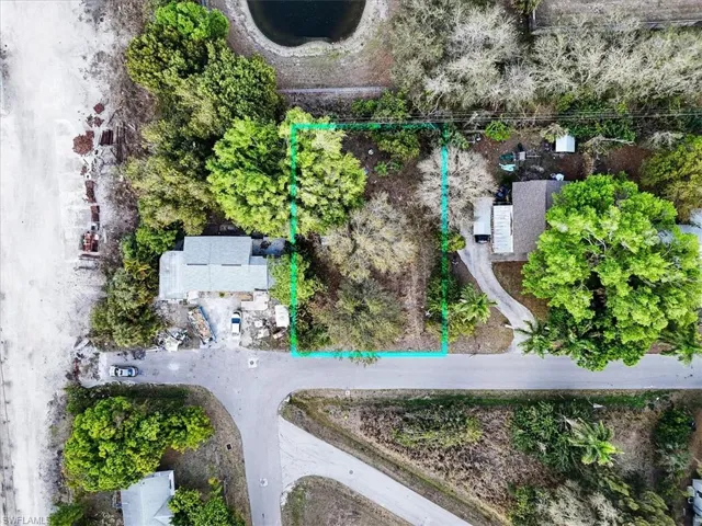 Aerial view of property and surrounding area featuring property parcel outlined