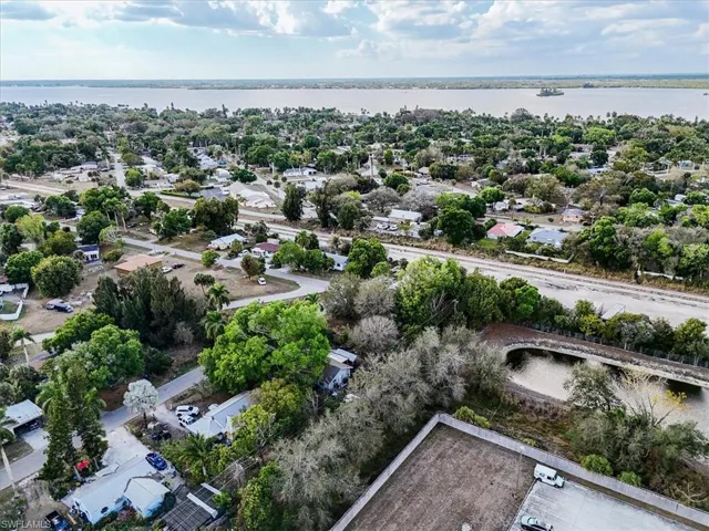 Aerial perspective of suburban area featuring a large body of water