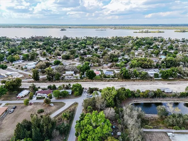 Aerial view of residential area featuring a nearby body of water