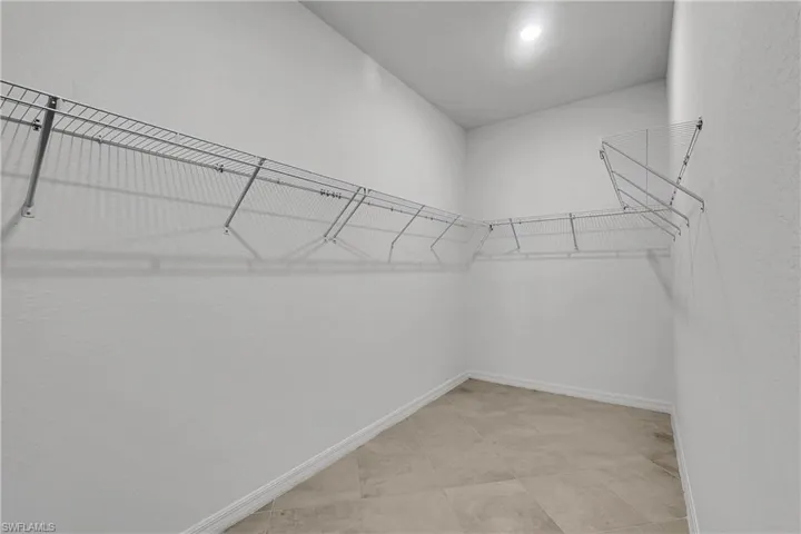 Huge walk-in closet adjoinds primary bedroom
