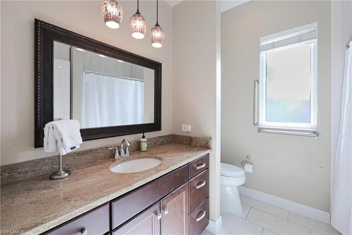Bathroom featuring tile patterned floors, vanity, and toilet
