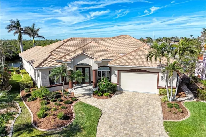 Mediterranean / spanish-style house featuring a front yard and a garage