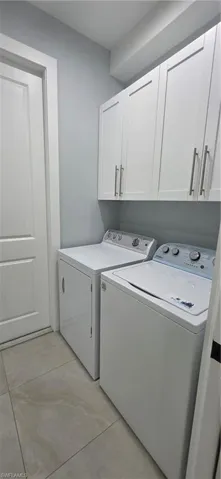 Laundry room with cabinet space and washing machine and clothes dryer