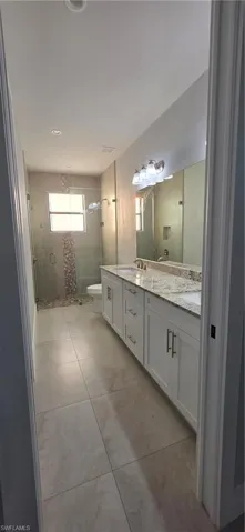 Full bathroom featuring vanity and a stall shower