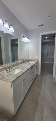 Full bath with double vanity and recessed lighting