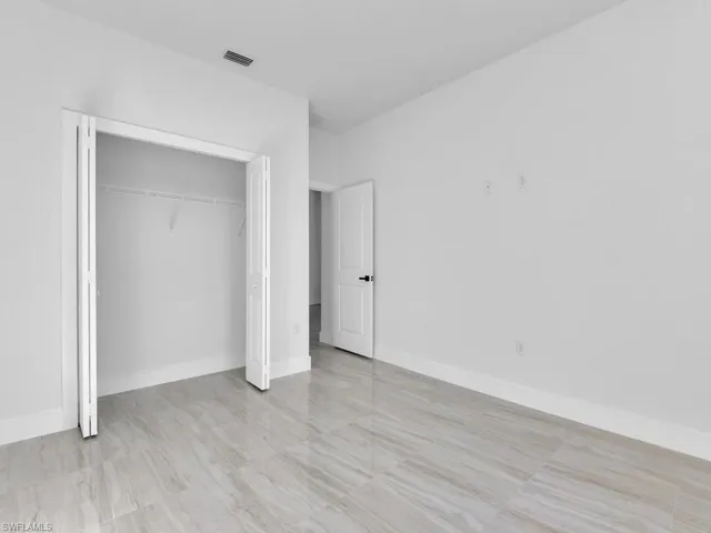 Unfurnished bedroom with a closet
