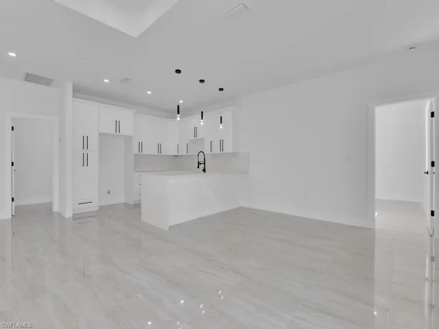 Unfurnished living room featuring sink