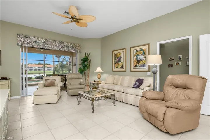 Living area with light tile patterned floors and a ceiling fan