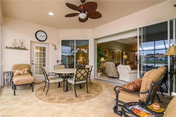 View of patio with outdoor dining area and ceiling fan