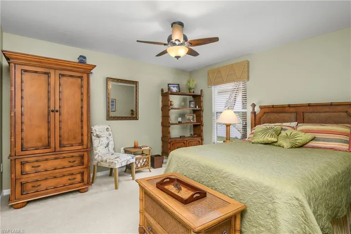 Bedroom with light carpet and ceiling fan