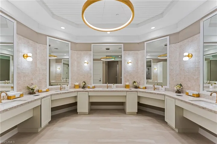 Women's bathroom featuring vanity and recessed lighting