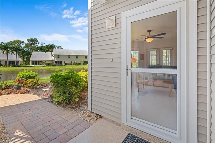 Doorway to property with ceiling fan