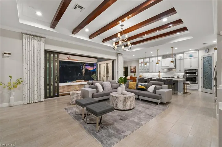 Spacious great room with wood beamed ceiling
