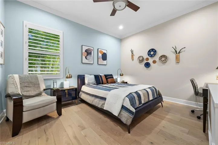 3rd bedroom with hardwood wood flooring. and built-out closet