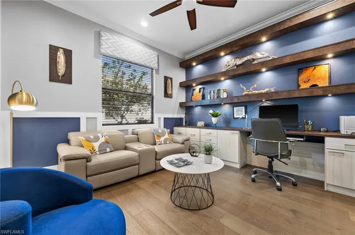 Office featuring wood shelving and wood flooring