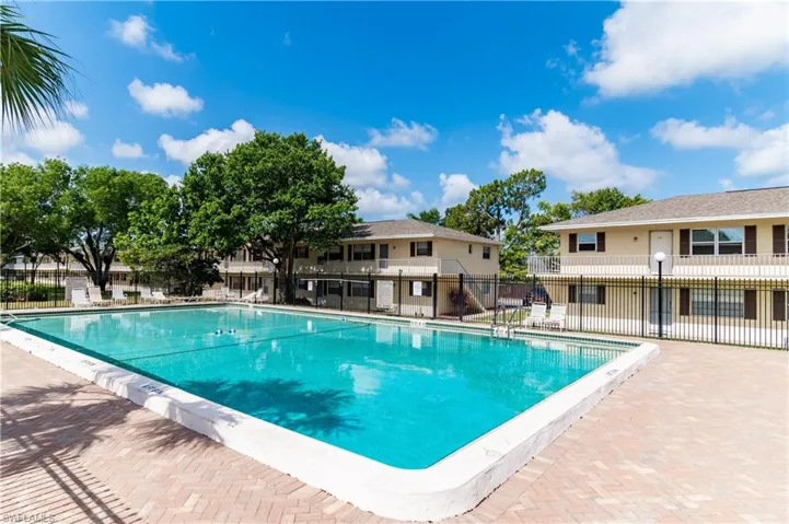 Community pool with a patio