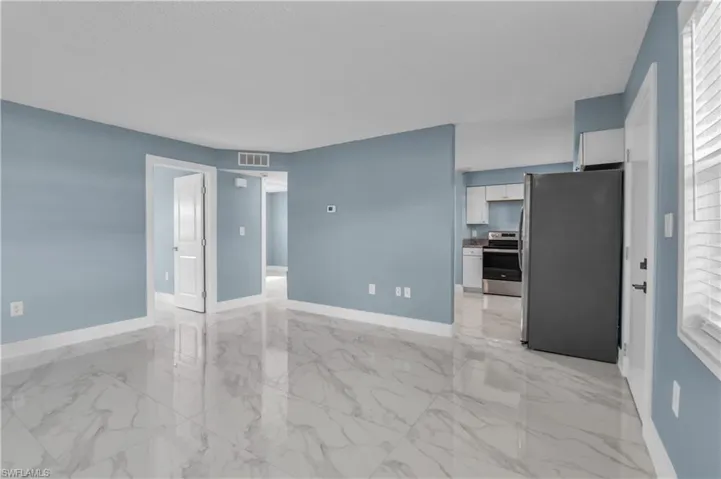 Empty room with light marble finish flooring and baseboards