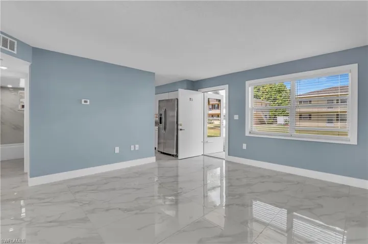 Empty room featuring light marble finish floors