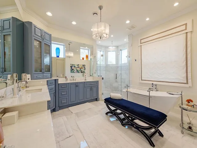 Full bath featuring a freestanding tub, recessed lighting, a sink, a shower stall, and crown molding