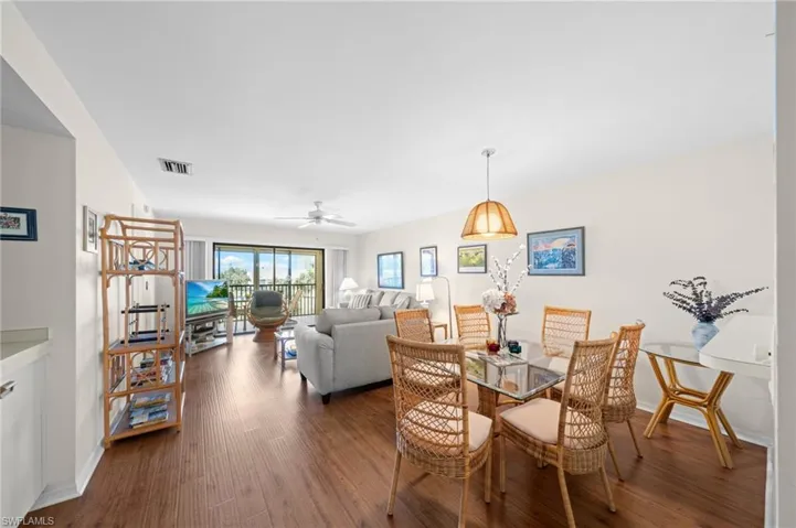 Dining room featuring dark wood-type flooring and ceiling fan