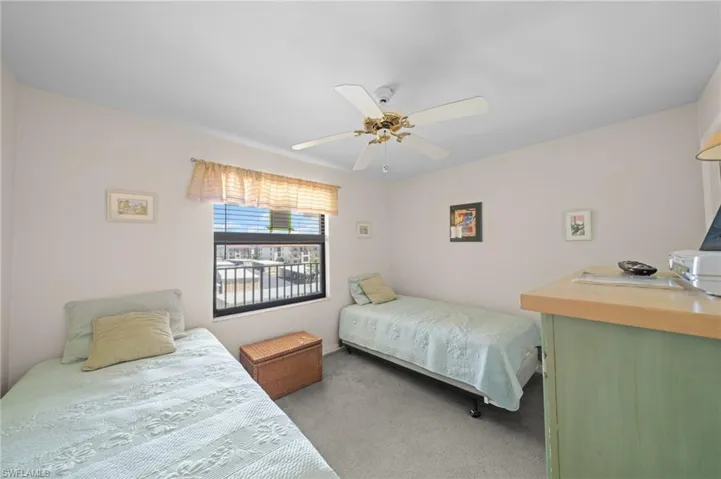 Bedroom featuring light carpet and a ceiling fan