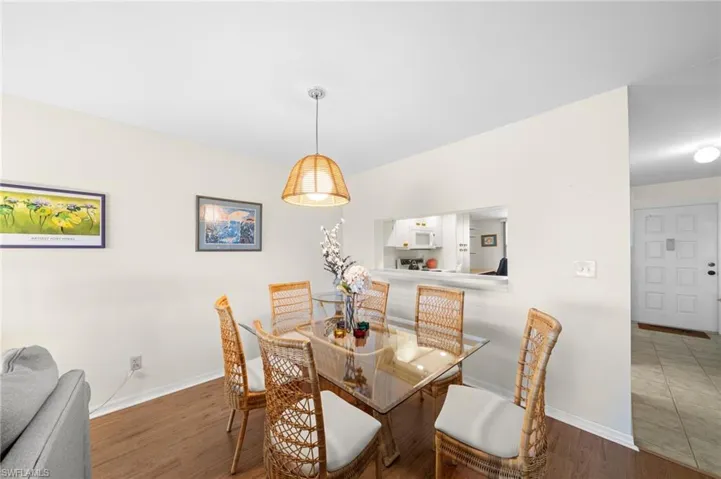 Dining space featuring wood finished floors and baseboards