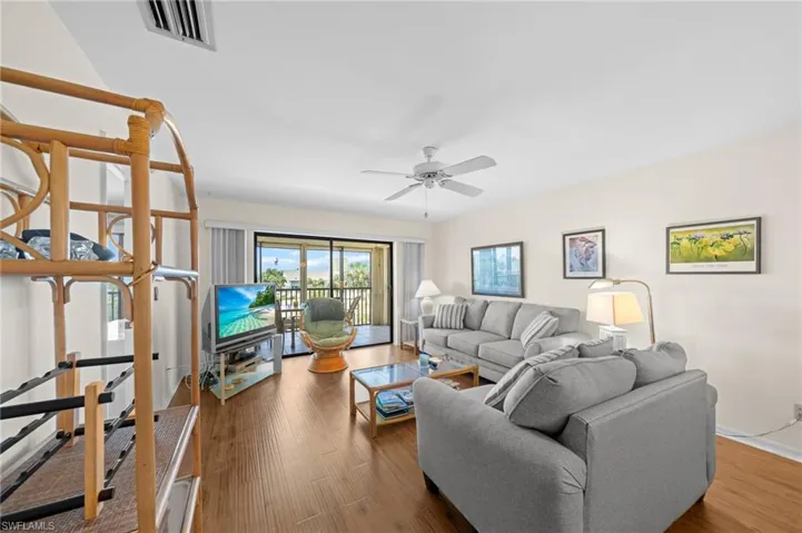 Living room with wood finished floors and a ceiling fan