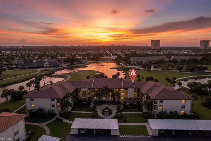 Aerial view at dusk of a water view and golf course view