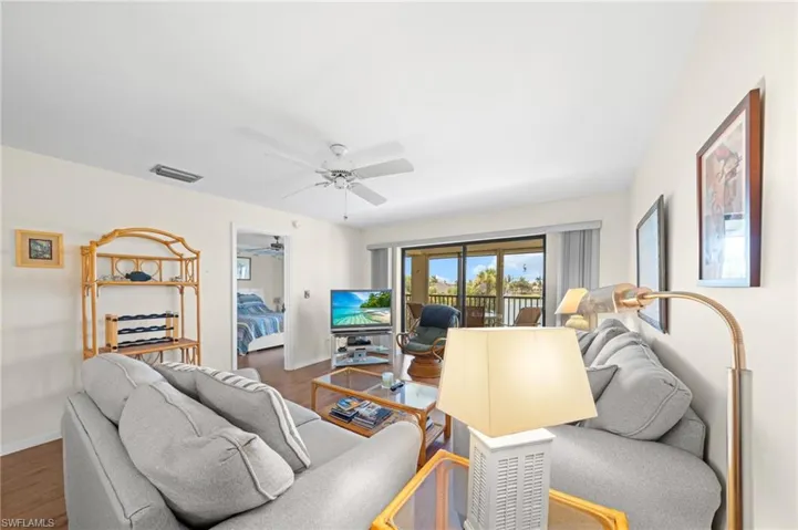 Living area featuring wood finished floors and ceiling fan
