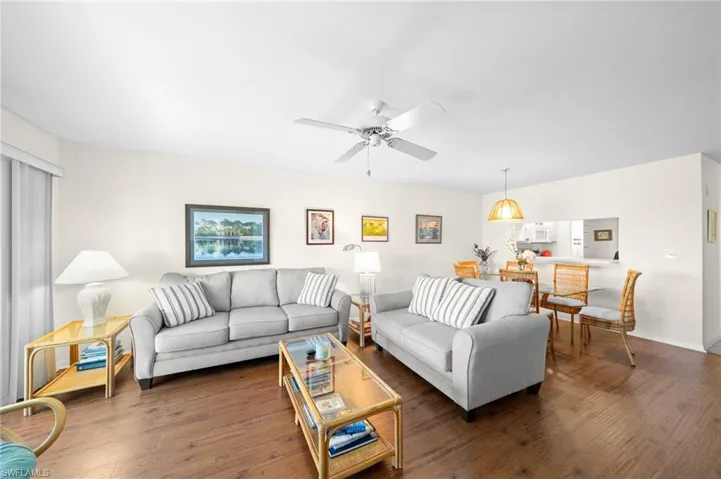 Living room with wood finished floors and a ceiling fan