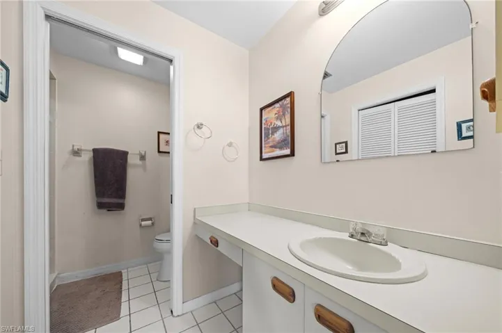 Full bathroom featuring light tile patterned flooring, vanity, and a shower with shower curtain