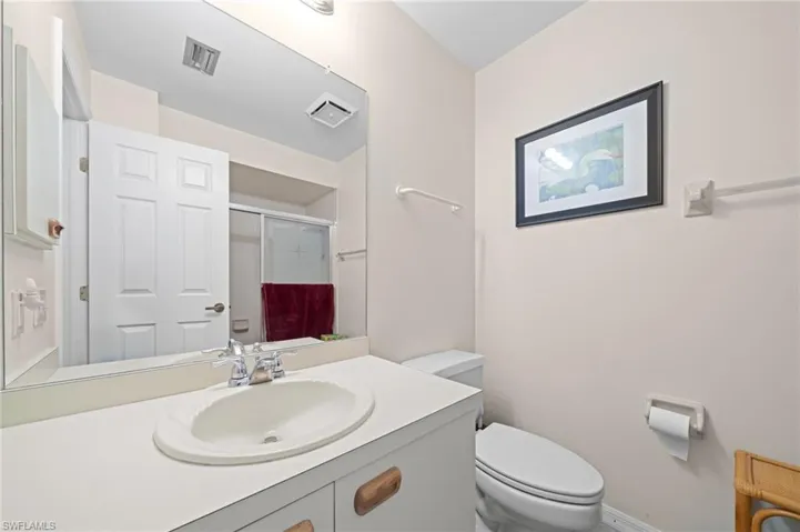 Bathroom with a shower stall and vanity