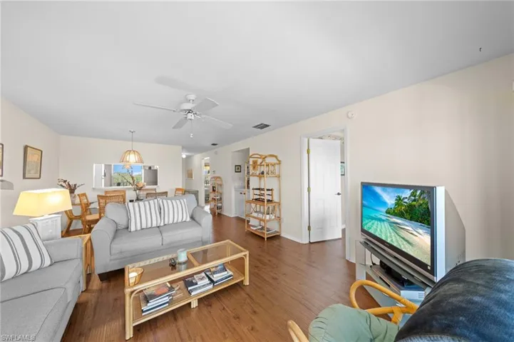 Living area with wood finished floors and ceiling fan