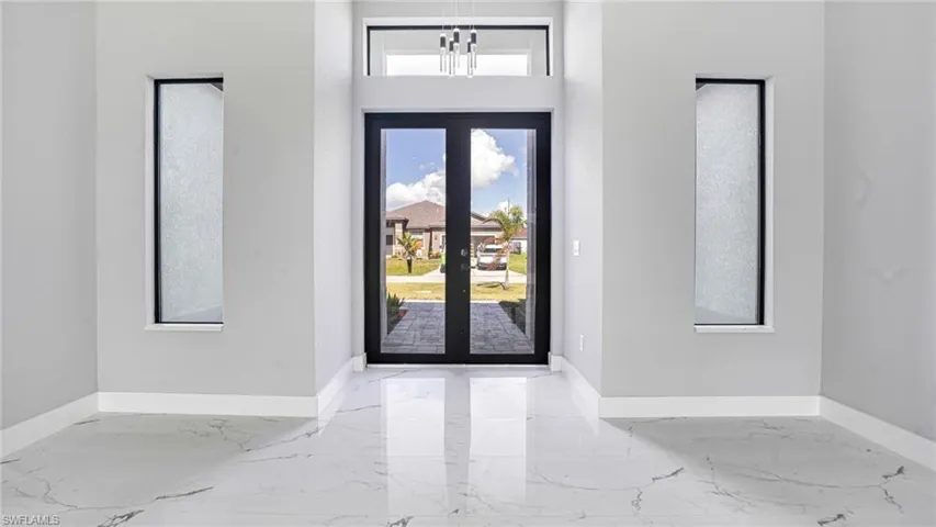 Foyer featuring a chandelier and french doors