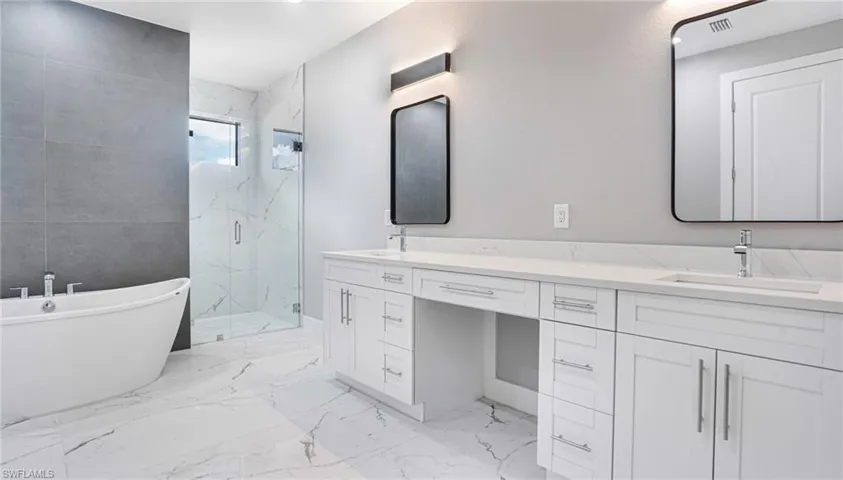 Bathroom featuring plus walk in shower and vanity