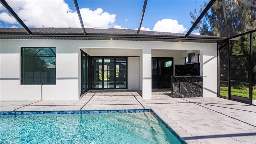 Rear view of property with a patio and glass enclosure