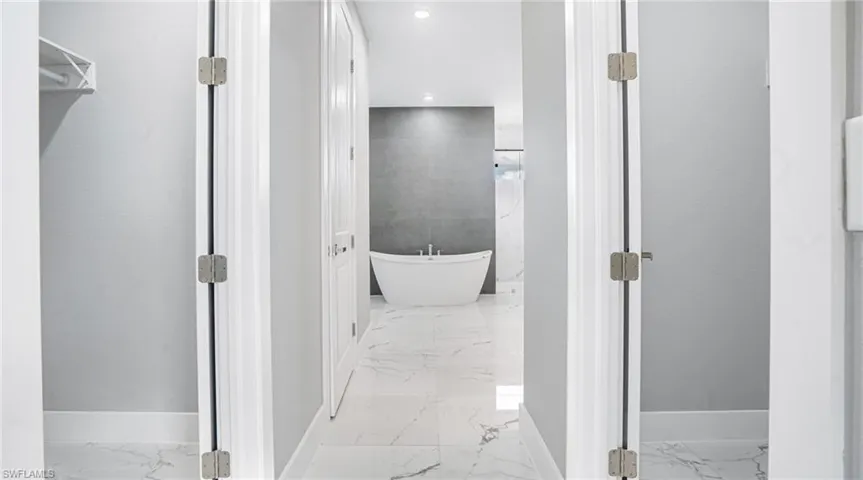 Bathroom featuring a bathtub and tile walls