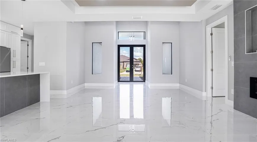 Entrance foyer with a raised ceiling and french doors