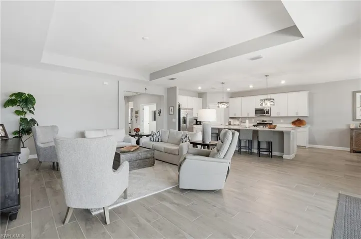 Living area with wood finish floors and recessed lighting
