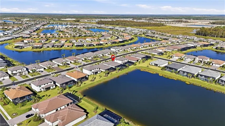 Aerial view of property's location with a nearby body of water and nearby suburban area