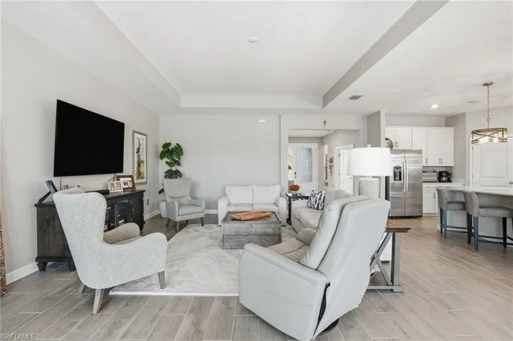 Living room with wood tiled floors and a raised ceiling