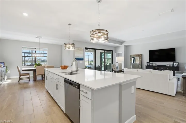 Kitchen with white cabinetry, light wood finished floors, decorative light fixtures, and recessed lighting