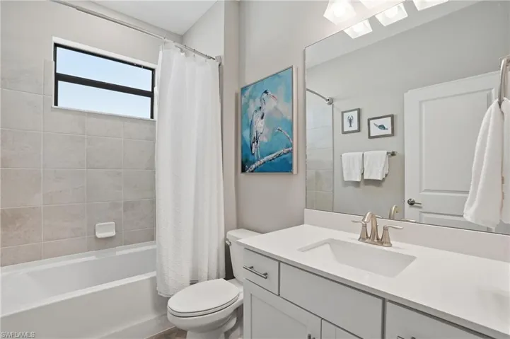 Bathroom featuring vanity and shower / tub combo