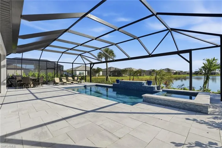 View of pool featuring a sunroom, a residential view, a lanai, and a patio area