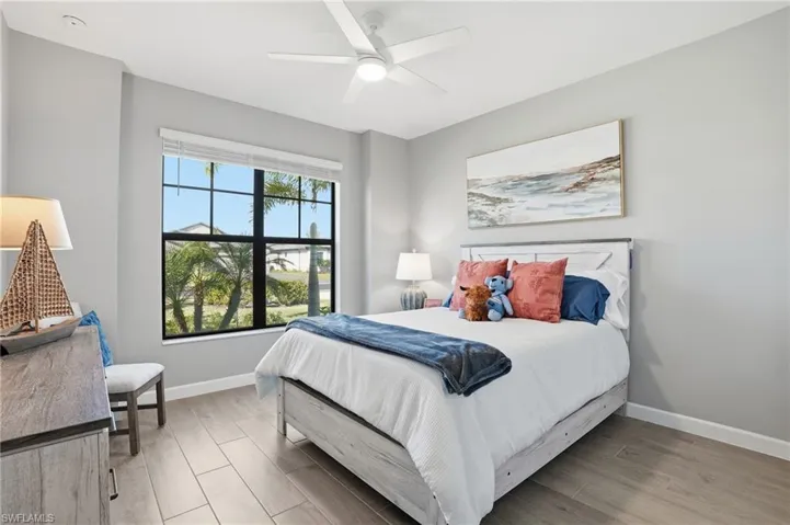 Bedroom with light wood-style floors and ceiling fan