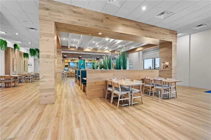 Dining space featuring wooden walls, light wood-style floors, recessed lighting, and a paneled ceiling