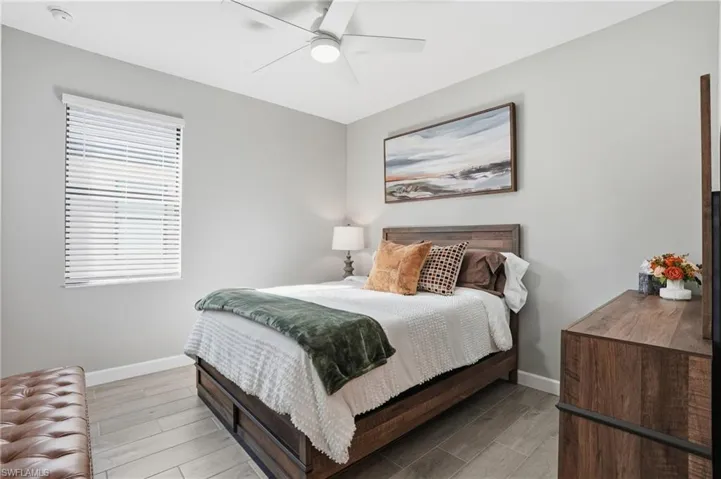 Bedroom with wood finish floors and a ceiling fan
