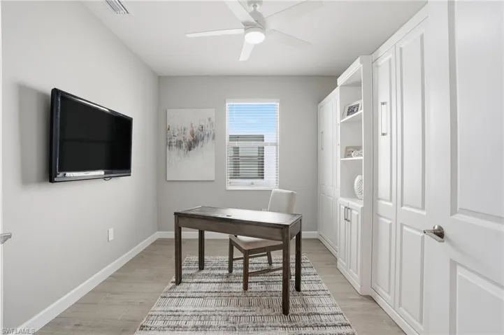 Office featuring light wood-type flooring and a ceiling fan